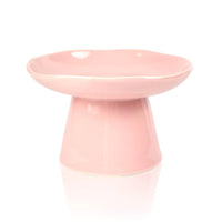 Cat eating slowly from the ridged ceramic dish