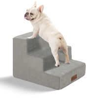 Small dog walking down the pet stairs from a bed